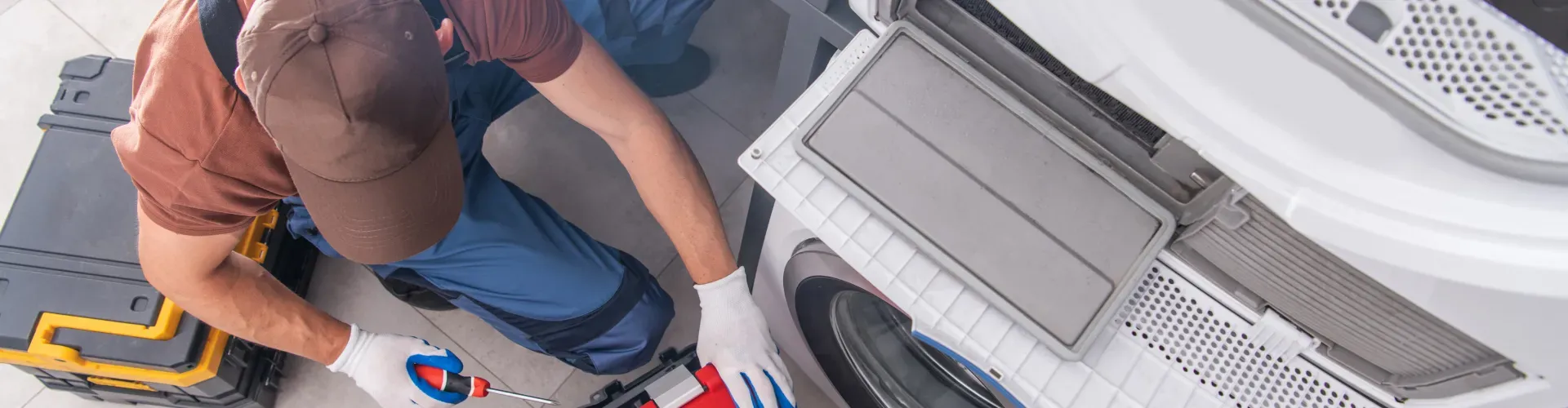 man-repairing-washer-and-dryer-hero